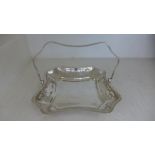 A silver hallmarked dish with hinged handle,