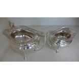 Two silver hallmarked items in the form of a milk jug and a sugar bowl,