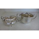 Two twin handled silver hallmarked cups one marked for London 1893/94 one marked for Birmingham