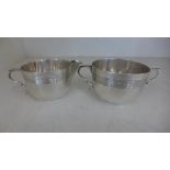 Two silver hallmarked items in the form of a milk jug and a sugar bowl both with ribbed banding