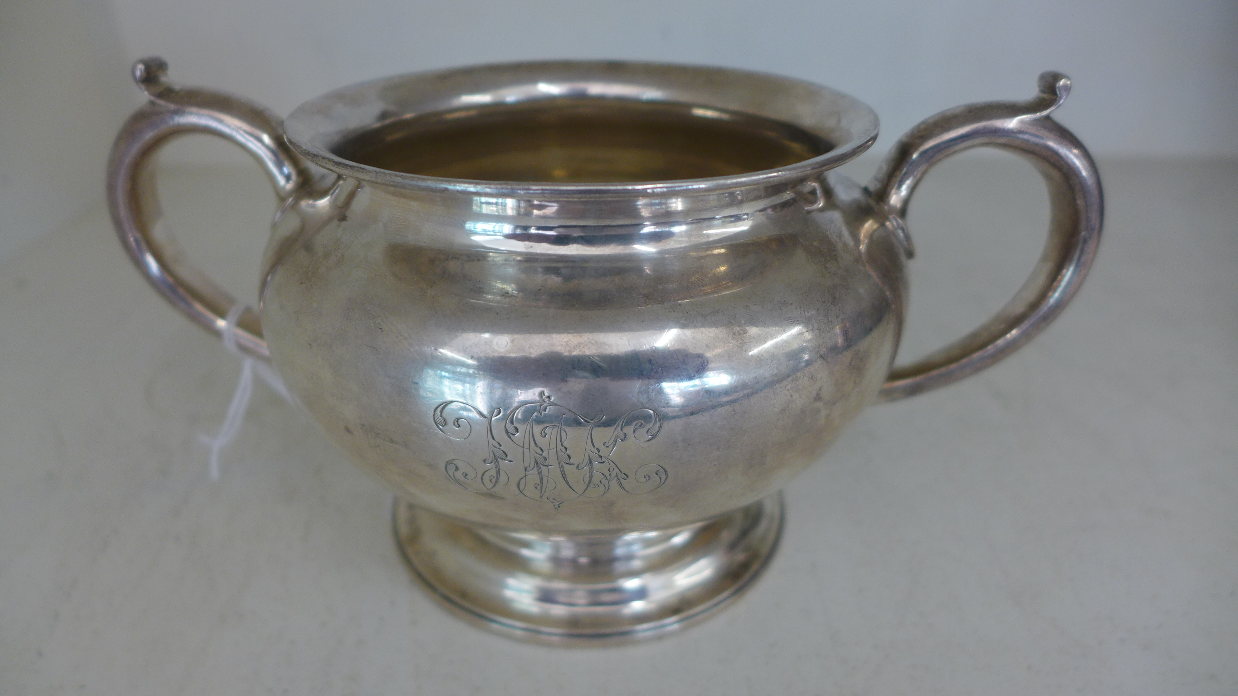 A silver hallmarked twin handled bowl of circular form raised on single pedestal base marked for