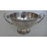 A silver hallmarked twin handled Christening cup with ribbed decoration to top and bottom engraved