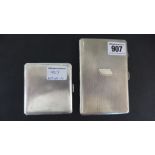 A large and a small silver cigarette case both with engine turned finish - the larger case