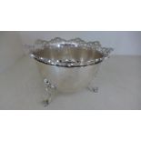 A silver hallmarked bowl with pierced decoration to top and raised on three scroll feet marked for