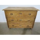 A Continental stripped pine three drawer chest - Height 96cm x 125cm x 61cm