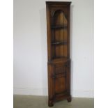 A small carved oak corner cupboard with a rich patina - Height 167cm