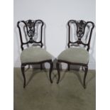 A pair of Edwardian carved walnut side chairs