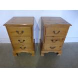 A pair of pine three drawer bedside chests