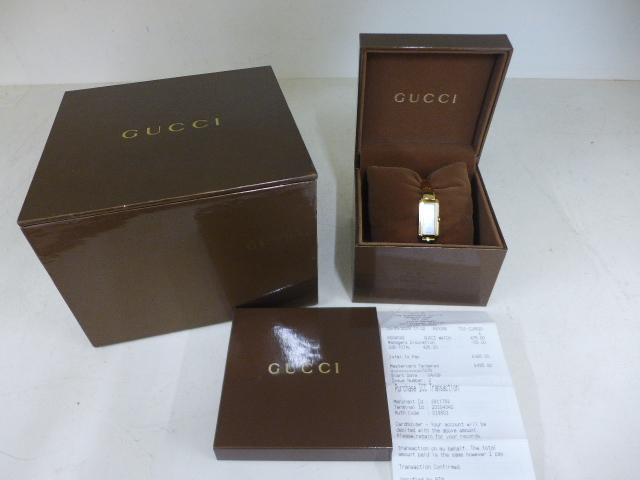 A gold plated Gucci ladies watch in stainless steel case - requires new battery