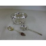 A silver hallmarked bowl raised on three pad feet, a souvenir spoon and a sifter spoon,