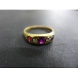 An 18ct yellow gold diamond and ruby ring size R - some usage wear,