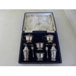 A silver hallmarked cruet set by Walker and Hall,