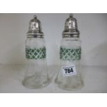 A pair of silver lidded sugar sifters, green and clear glass circa 1915 - good condition,