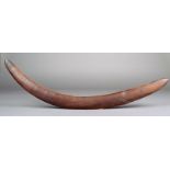 An Aboringine boomerang one end with scratched linear decoration 60.5cm high.