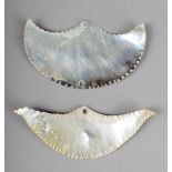 Two Solomon Island mother of pearl ornaments of gorget form with serrated edges 7cm and 7.7cm