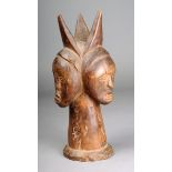 An Idoma triple head crest Nigeria with horn like coiffure and bared teeth on a conical stem with