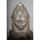 A Mende helmet mask Sierra Leone with a plaited coiffure and ribbed central crest with finials and a