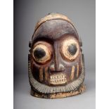 A Ekiti helmet mask Nigeria the crown carved a cross symbol with large eyes and bared teeth and with