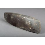 A Neolithic adze blade of rectangular form with pointed ends 28.5cm long.