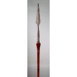 A Naga spear India with a metal tip and wooden shaft with died hair mounts 231cm long.