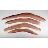 Four Aborigine boomerangs one with engraved linear decoration 58cm long. (4)