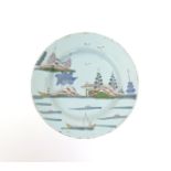 A delftware plate  mid 18th century, painted in polychrome enamels with figures fishing from boats