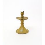 An early English pottery candlestick  17th century, raised on a tall flared foot with wide drip
