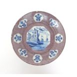 A Wincanton or Bristol delftware plate  c.1740, painted with an octagonal panel to the well of two