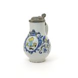 A Delft jug or tankard  18th century, the ovoid body painted in polychrome enamels with two winged