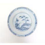 An Irish delftware plate  mid 18th century, decorated with bamboo and flowering peony beside an