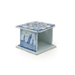 A delft warming stand  18th or 19th century, the square form finely potted and decorated to two