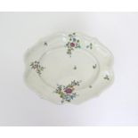 A Strasbourg faïence dish  c.1770, painted in rich enamels with sprays of flowers and scattered