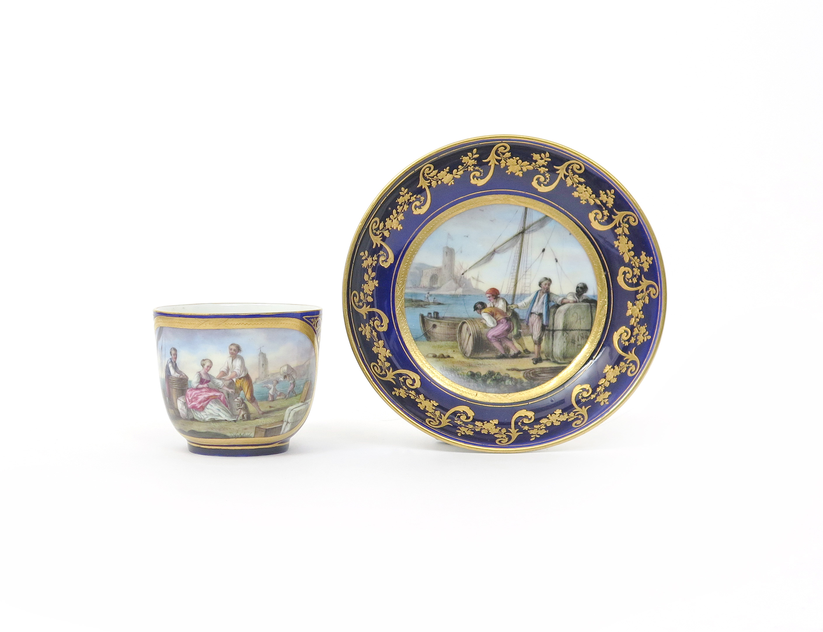 A Sevres cup and saucer c.1782, painted by Jean-Louis Morin with scenes of figures rolling barrels