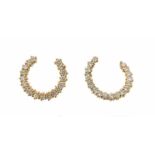 A pair of diamond hoop earrings, designed as a crescent of circular-cut diamonds in yellow gold. 2cm