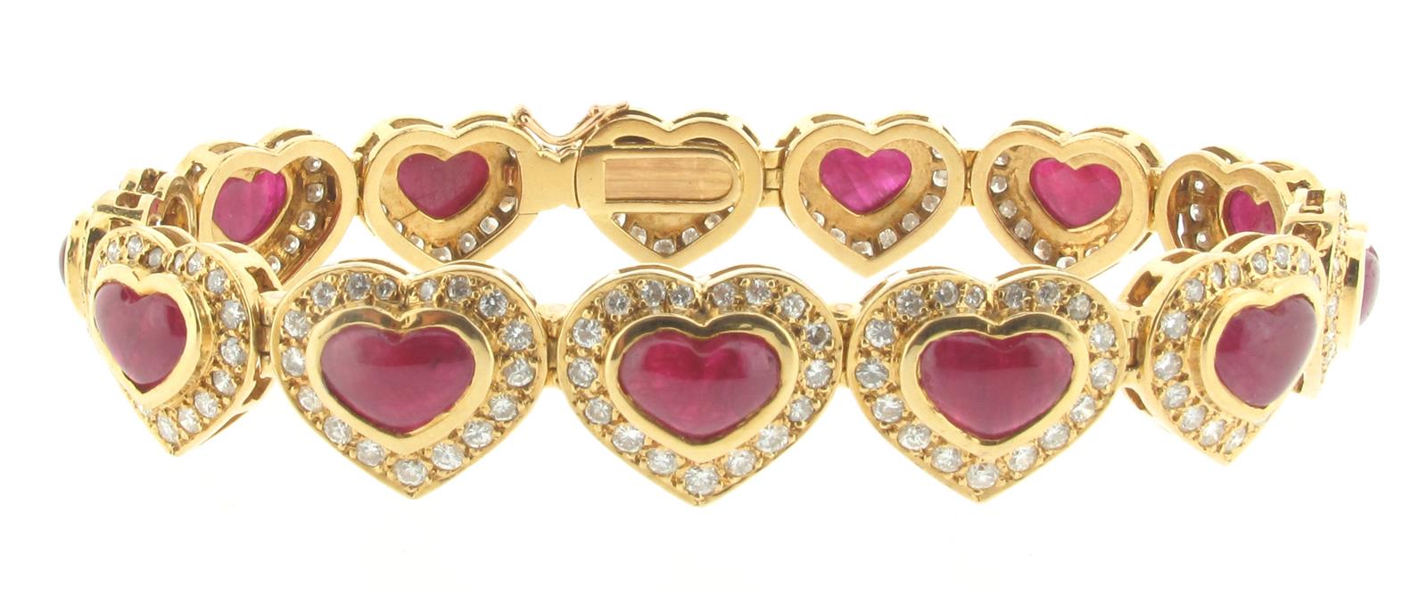 A ruby and diamond bracelet, designed as thirteen hearts, each set with a cabochon ruby within a