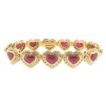 A ruby and diamond bracelet, designed as thirteen hearts, each set with a cabochon ruby within a