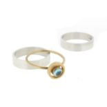 A collection of rings by Wendy Ramshaw, including a circular gold ring mounted with an aquamarine