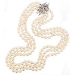 A three row cultured pearl necklace, the pearls measure approximately 8.00mm, with a diamond-set