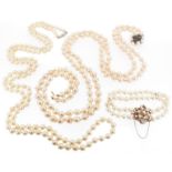 A two row cultured pearl necklace, with a cultured pearl and gem-set clasp. A two row cultured pearl