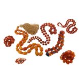 Six amber bead necklaces, one with graduated melon-carved amber beads alternately mounted with