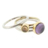 Four rings by Wendy Ramshaw, set with an amethyst cabochon and a smokey quartz cabochon, with two