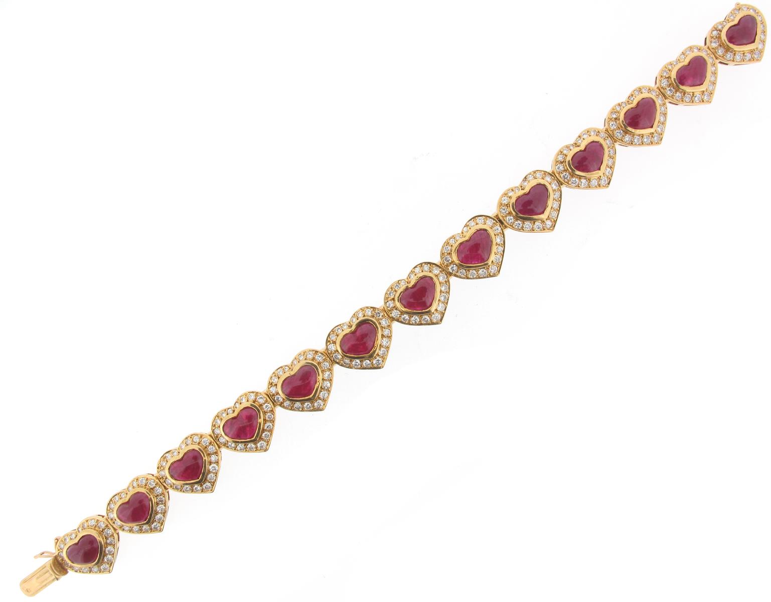 A ruby and diamond bracelet, designed as thirteen hearts, each set with a cabochon ruby within a - Image 2 of 2