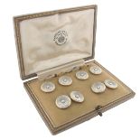 A set of mother of pearl and enamel dress studs and cufflinks, the circular discs applied with a