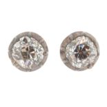 A pair of diamond stud earrings, each set with an old cushion-shaped diamond in silver and gold