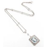 An aquamarine and diamond pendant, the emerald-cut aquamarine is set within a surround of circular-