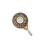 A CHINESE CIRCULAR JADE-MOUNTED HAND MIRROR, QING DYNASTY The handle formed from a pale celadon jade