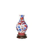 A CHINESE LOBED DRAGON VASE, 19TH CENTURY Painted in underglaze blue and overglaze red enamels