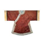 A CHINESE BROWN SILK LADY’S SURCOAT, 19TH CENTURY Decorated with geometric flowerheads, the