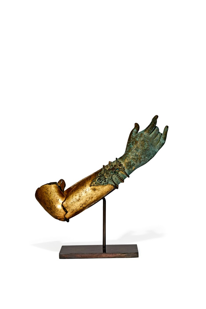 A NEPALESE GILT BRONZE MODEL OF BUDDHA’S ARM, 17TH CENTURY The wrist adorned with bracelets