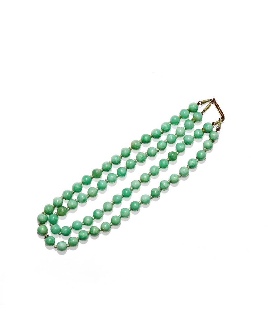 A CHINESE JADEITE NECKLACE, 20TH CENTURY With two strings of circular beads joined by a metal clasp,